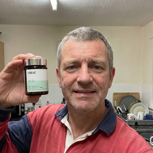 Customer holding the jar in his kitchen