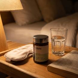 Jar on a bedside table with a lamp and eye mask